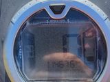 a close up of a parking meter with a clock on it