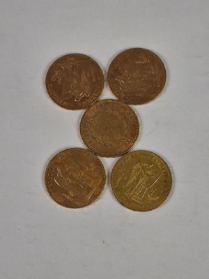 four different coins sitting on top of each other on a white surface
