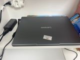 a laptop that is sitting on a table with a remote