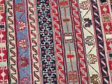 an image of a red and blue rug with a pattern on it