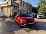 the red car is parked in front of the building