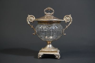 a silver vase with a lid on a stand