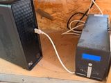 a computer and a power supply sitting on the floor