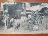 an old black and white photo of a group of people and animals