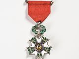 a red ribbon with a silver star on it