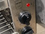 a close up of a metal oven with a red light