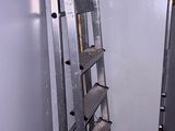 a ladder that is leaning against a wall in a room