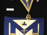 an image of a blue and gold masonic apron with a cross on it