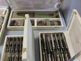 many forks and spoons in a wooden box