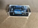 a model of a car in a box on the floor