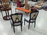 two chairs that are sitting in the middle of a room
