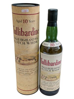 a bottle of tullibardine whisky next to a cardboard box