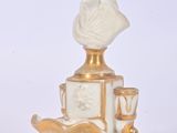 a statue of a man sitting on top of a table