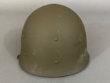 an army helmet sitting on a table with a white background
