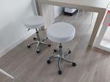 two white stools sitting at a table in a room