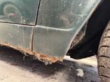 a close up of a dirty car with a tire on it