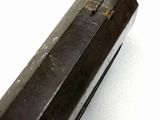 a close up of a metal object on a white surface