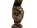 a statue of a woman holding a flower on top of a pedestal
