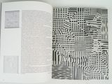 an open book with black and white designs on it