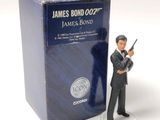a figurine of a man holding a gun in front of a box