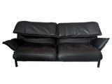 black leather loveseat with two reclinings on the back
