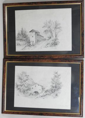 two framed drawings of a house and a house in the woods