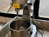 a mixer sitting on a counter in front of a window