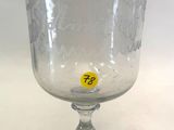 a clear glass with a yellow sticker on it