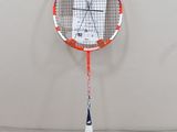 a tennis racket that is sitting on the floor