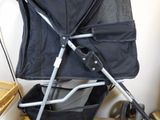 a black stroller with a black seat and a black handlebar