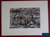 framed photograph of a group of soldiers standing in front of a pile of bags
