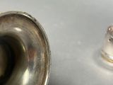 a silver object on the table next to a silver object