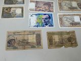 several different bank notes are laid out on a table