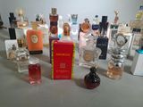 many bottles of perfume sitting on a table