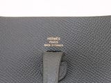 the black leather purse has a gold metal clasp on it