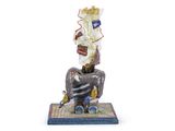 a figurine of a man sitting on a chair