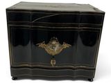 a black chest with a gold decoration on it