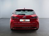 the rear end of a red toyota corollant parked in a room