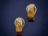a pair of gold and diamond earrings