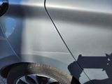 a person using a power drill to fix a car ' s tire