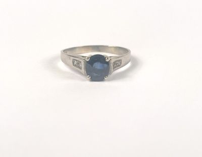 a blue sapphire and diamond ring on a white background