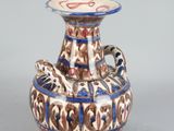 a blue and white vase with a cat on it
