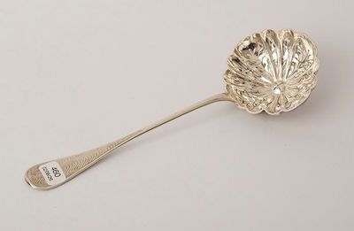 an antique silver spoon with a leaf design on it and a spoon with a spoon handle