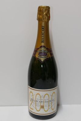 the bottle of champagne is sitting on a white surface