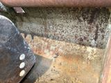 a close up of a rusted piece of metal on the ground