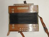 an old accordion sitting on a white surface