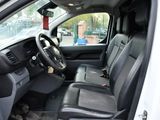the interior of a white truck with black leather seats and a steering wheel