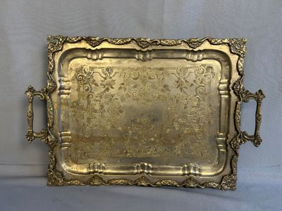 an ornate brass tray with handles and handles on a white background