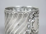 a close up of a silver cup on a table