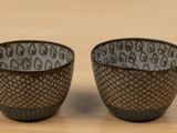 two cups that are sitting on a table